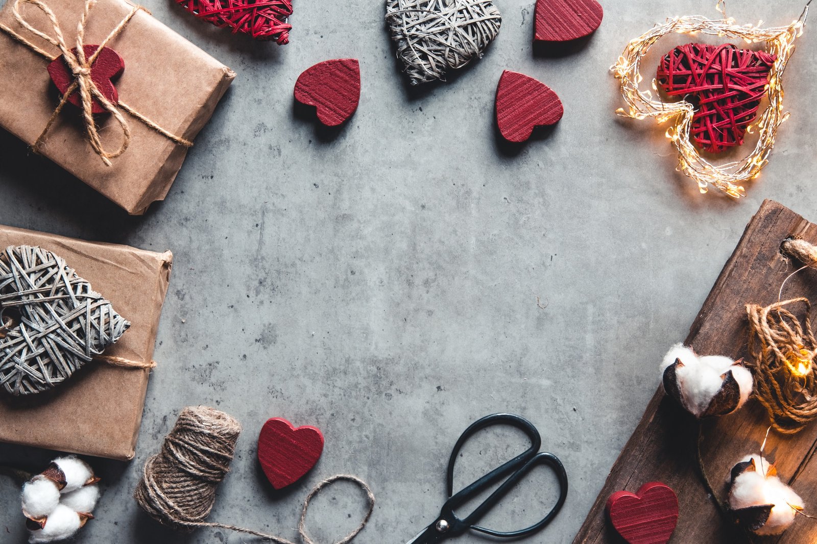 Gift wrapping accessories. Gifts in craft paper on a gray background. Valentine's day